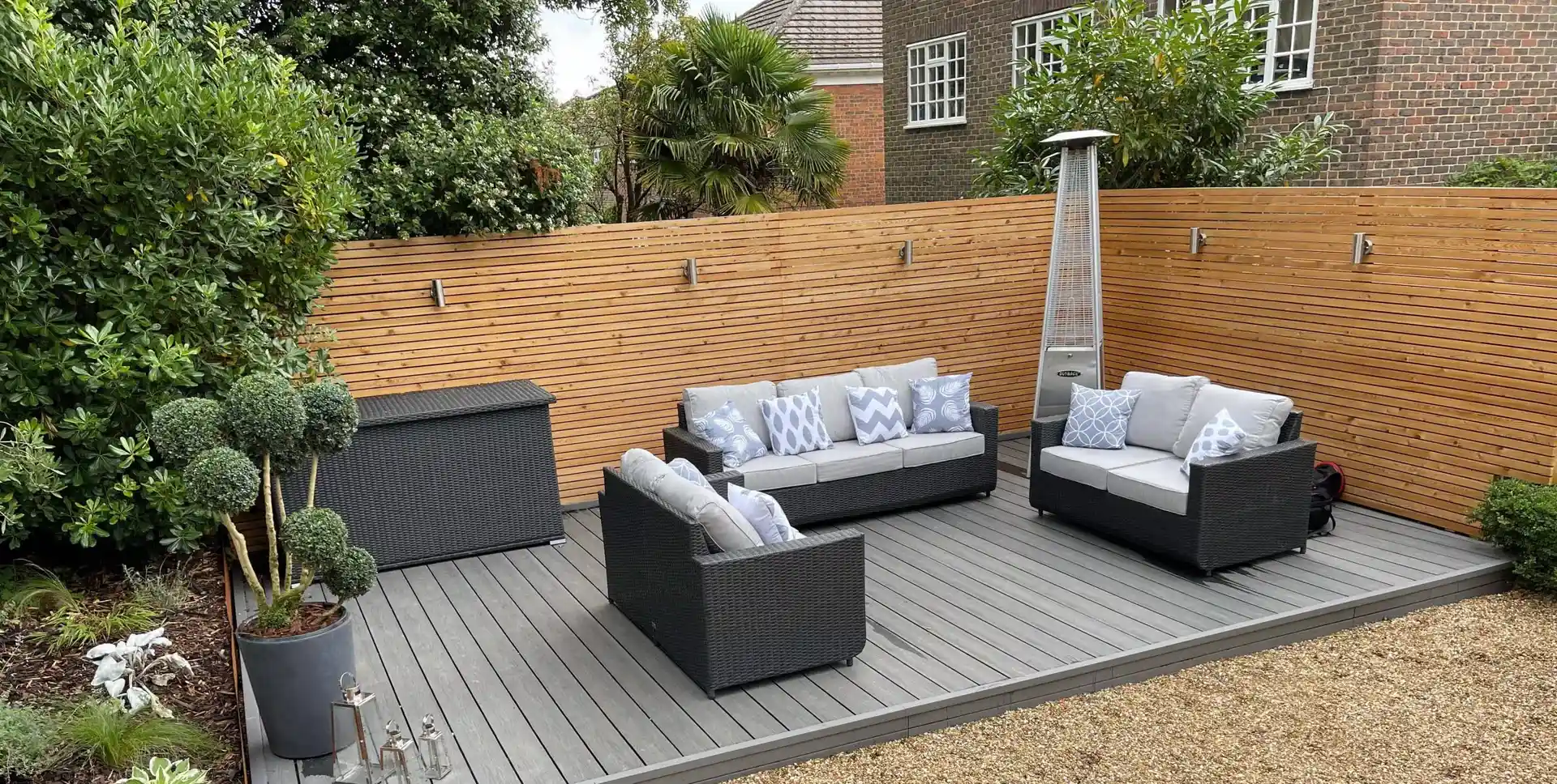 Composite decking with slatted timber fencing by Kingsley Build Group