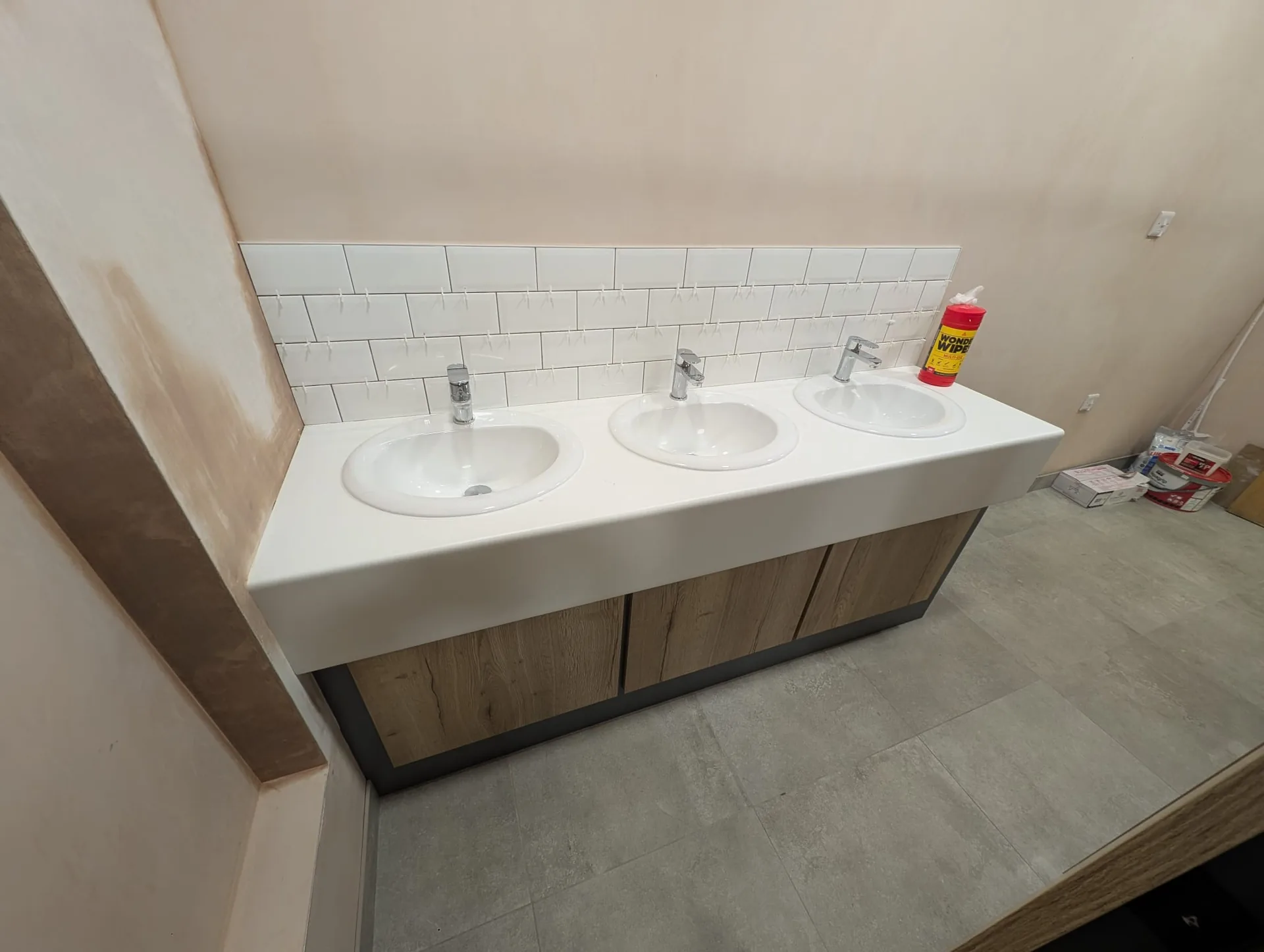 Refurbished washroom with a three-basin vanity unit