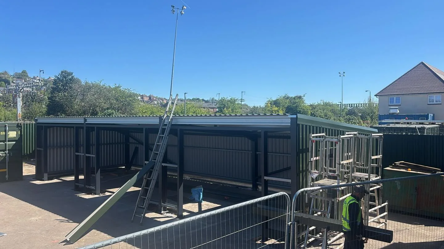 Steel-frame structure going up on a secured construction site