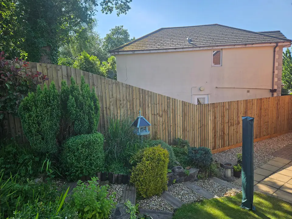 New feather-edge fence along a sloping garden