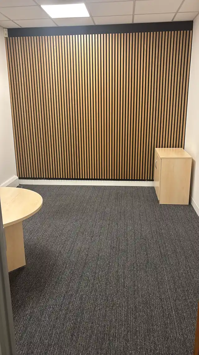Oak-slat feature wall in a refurbished office